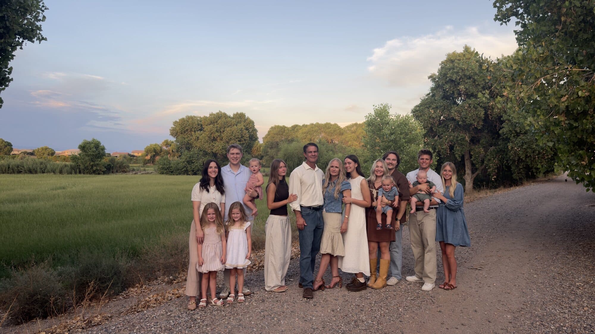 Tami and Chance with their family on a path beside a green field near Queen Creek, Arizona